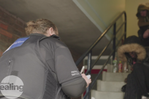 Enforcement officer speaking to residents in a stairwell