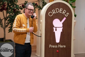 Man (Alan Carr) holding a telephone receiver