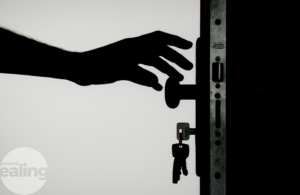 A hand reaching to open a door
