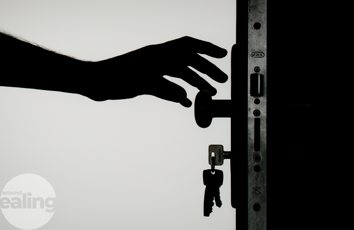 A hand reaching to open a door