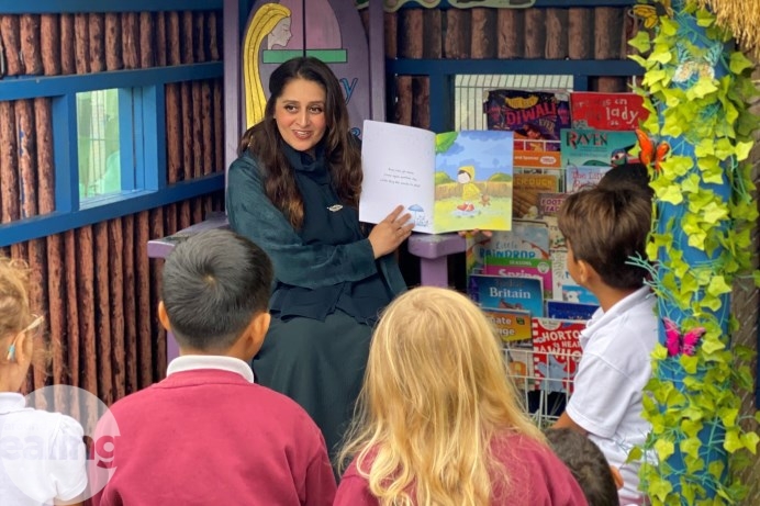 Zainab reading her book to the primary school's pupils