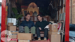 TV stars Ant and Dec in the back of a truck surrounded by household objects