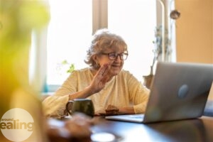 An elderly woman on a laptop