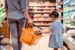 A mum and her young daughter shopping in a supermarket
